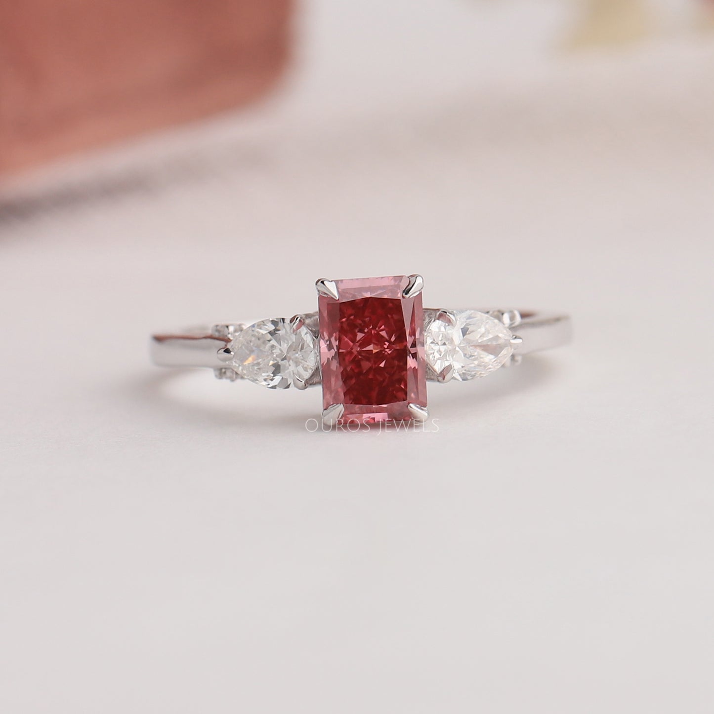 Pink Radiant And Pear Cut three Stone Ring